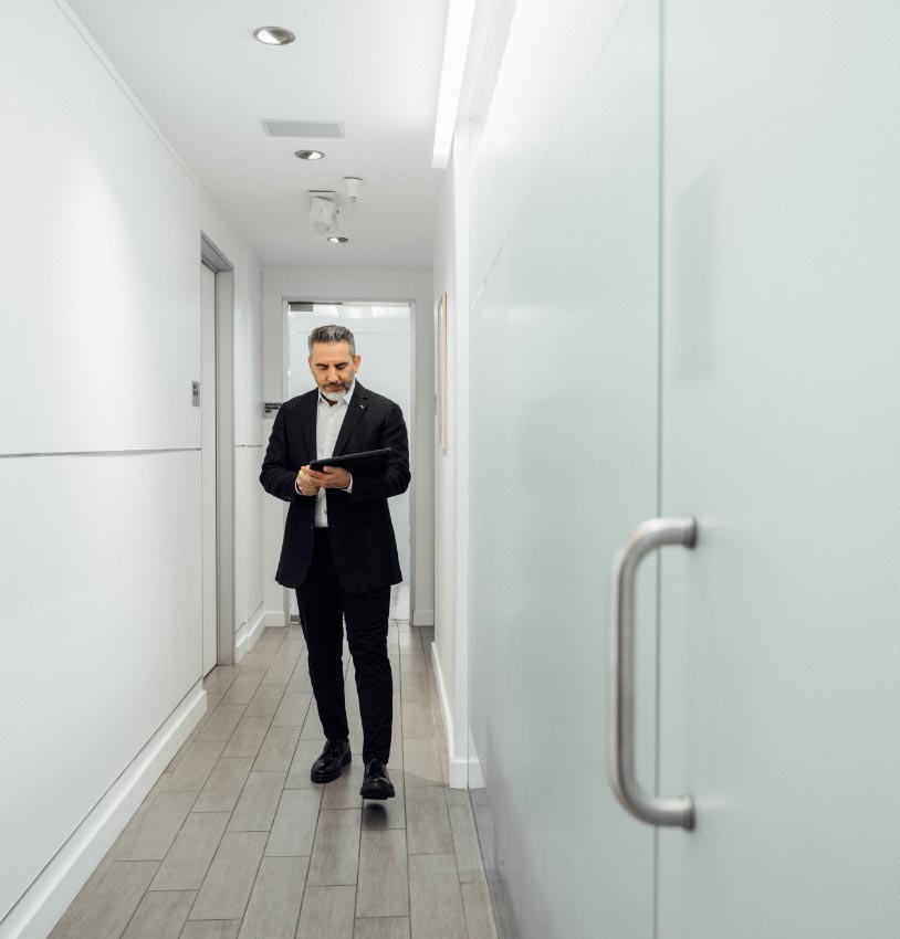 David Saadat, MD standing in hallway of his office